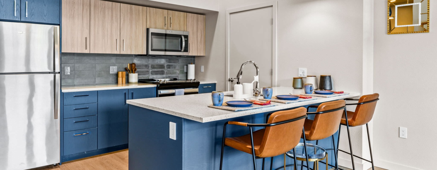 a kitchen with a blue table and chairs