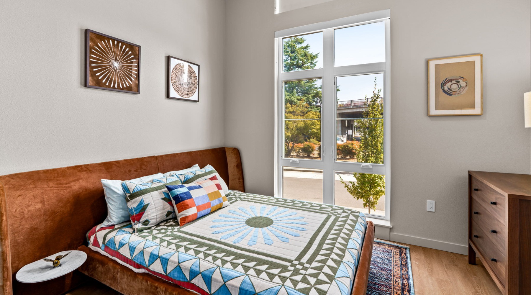 a bedroom with a bed and a large window