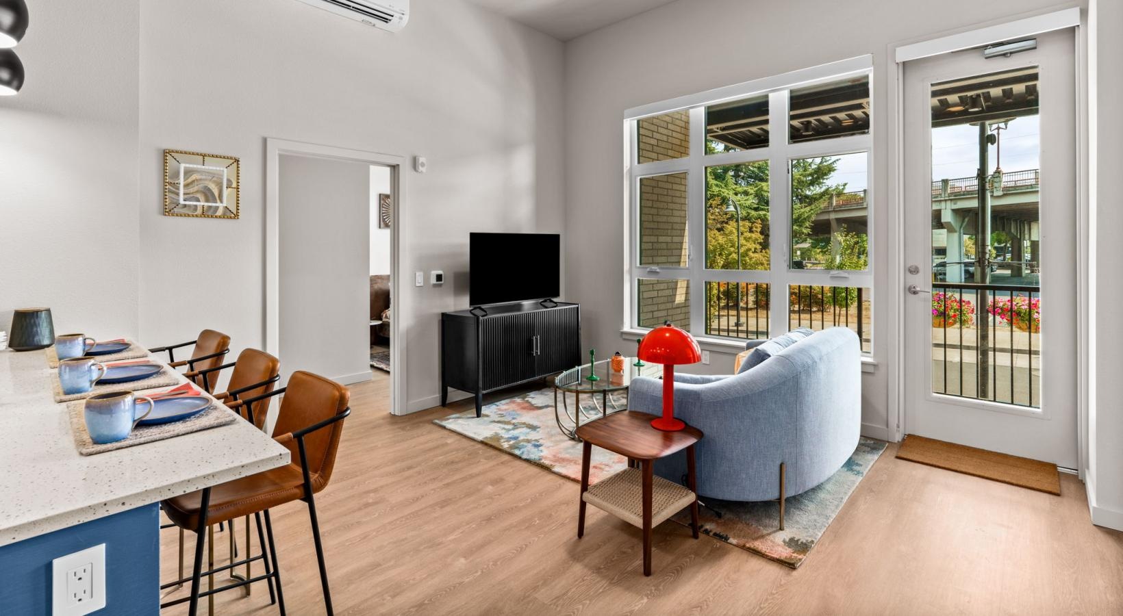 a living room with a tv, couch and chairs