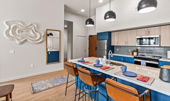 a kitchen with an island and chairs